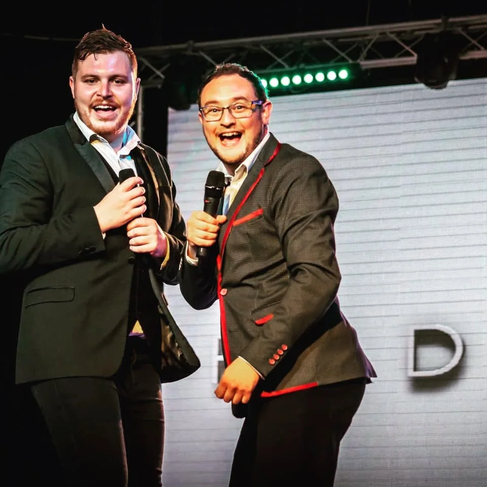Bradley presenting on stage with a fellow host