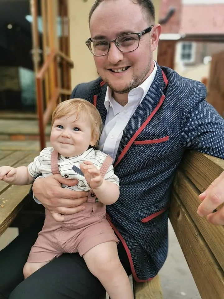 Bradley smiling in a smart jacket